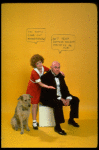 Actress Andrea McArdle as Annie w. Sandy and Reid Shelton as Daddy Warbucks w. comic strip balloons above them; from the Broadway production of the musical "Annie."