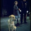 Actress Andrea McArdle as Annie w. Sandy and a policeman in a scene from the Broadway production of the musical "Annie."