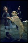 Actress Andrea McArdle as Annie w. Sandy and a policeman in a scene from the Broadway production of the musical "Annie."