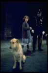 Actress Andrea McArdle as Annie w. Sandy and a policeman in a scene from the Broadway production of the musical "Annie."