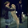 Actress Andrea McArdle as Annie w. Sandy and a policeman in a scene from the Broadway production of the musical "Annie."