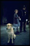Actress Andrea McArdle as Annie w. Sandy and a policeman in a scene from the Broadway production of the musical "Annie."