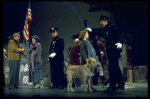 Actress Andrea McArdle as Annie w. Sandy and Hooverville-ites in a scene from the Broadway production of the musical "Annie."