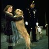 Actress Andrea McArdle as Annie w. Sandy and a policeman in a scene from the Broadway production of the musical "Annie."