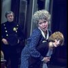 R-L) Actresses Dorothy Loudon as Miss Hannigan and Shelley Bruce as Annie w. a policeman in a scene from the Broadway production of the musical "Annie."