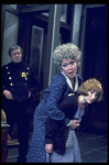 R-L) Actresses Dorothy Loudon as Miss Hannigan and Shelley Bruce as Annie w. a policeman in a scene from the Broadway production of the musical "Annie."