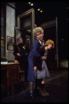 R-L) Actresses Dorothy Loudon as Miss Hannigan and Shelley Bruce as Annie w. a policeman in a scene from the Broadway production of the musical "Annie."