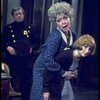 R-L) Actresses Dorothy Loudon as Miss Hannigan and Shelley Bruce as Annie w. a policeman in a scene from the Broadway production of the musical "Annie."