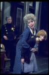 R-L) Actresses Dorothy Loudon as Miss Hannigan and Shelley Bruce as Annie w. a policeman in a scene from the Broadway production of the musical "Annie."