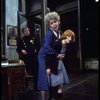 R-L) Actresses Dorothy Loudon as Miss Hannigan and Shelley Bruce as Annie w. a policeman in a scene from the Broadway production of the musical "Annie."