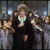 Actress Patricia Drylie as Miss Hannigan w. orphans in a scene from the Dallas production of musical "Annie."