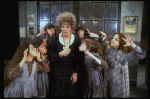 Actress Patricia Drylie as Miss Hannigan w. orphans in a scene from the Dallas production of musical "Annie."