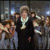 Actress Patricia Drylie as Miss Hannigan w. orphans in a scene from the Dallas production of musical "Annie."