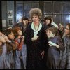 Actress Patricia Drylie as Miss Hannigan w. orphans in a scene from the Dallas production of musical "Annie."