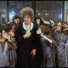 Actress Patricia Drylie as Miss Hannigan w. orphans in a scene from the Dallas production of musical "Annie."