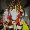 Roseanne Sorrentino as Annie w. Sandy, Santa Claus and orphans in a scene from the Dallas production of musical "Annie." 
