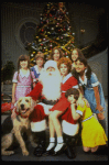 Roseanne Sorrentino as Annie w. Sandy, Santa Claus and orphans in a scene from the Dallas production of musical "Annie." 
