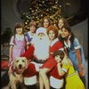 Roseanne Sorrentino as Annie w. Sandy, Santa Claus and orphans in a scene from the Dallas production of musical "Annie." 
