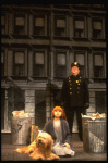 Mary K. Lombardi as Annie w. Sandy and a policeman in a scene from the Chicago production of the musical "Annie."