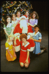 Mary K. Lombardi as Annie w. Santa Claus and orphans in a scene from the Chicago production of the musical "Annie."