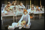 Actress Mary K. Lombardi as Annie (C) w. orphans in a scene from the Chicago production of the musical "Annie."