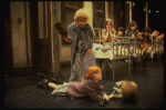 Alice Ghostley as Miss Hannigan and Allison Smith as Annie w. orphans in a scene from the Broadway production of the musical "Annie."