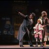 Kristi Coombs as Annie and Reid Shelton as Daddy Warbucks w. Grace in a scene from the New Orleans production of the musical "Annie."