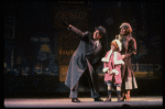 Kristi Coombs as Annie and Reid Shelton as Daddy Warbucks w. Grace in a scene from the New Orleans production of the musical "Annie."