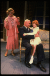 Kristi Coombs as Annie and Reid Shelton as Daddy Warbucks w. Grace in a scene from the New Orleans production of the musical "Annie."