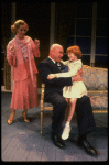 Kristi Coombs as Annie and Reid Shelton as Daddy Warbucks w. Grace in a scene from the New Orleans production of the musical "Annie."