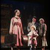Kristi Coombs as Annie and Reid Shelton as Daddy Warbucks w. Grace in a scene from the New Orleans production of the musical "Annie."
