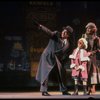 Kristi Coombs as Annie and Reid Shelton as Daddy Warbucks w. Grace in a scene from the New Orleans production of the musical "Annie."