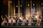 Kristi Coombs as Annie (C) w. orphans in a scene from the New Orleans production of the musical "Annie."