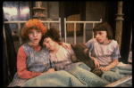 Kristi Coombs as Annie (L) w. orphans in a scene from the New Orleans production of the musical "Annie."