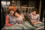 Kristi Coombs as Annie (L) w. orphans in a scene from the New Orleans production of the musical "Annie."