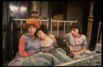Kristi Coombs as Annie (L) w. orphans in a scene from the New Orleans production of the musical "Annie."