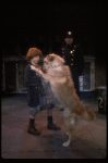 Kristi Coombs as Annie w. Sandy and a policeman in a scene from the New Orleans production of the musical "Annie."