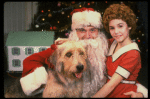 Roseanne Sorrentino as Annie w. Santa Claus and Sandy in a scene from the touring company of the musical "Annie." (Louisville)