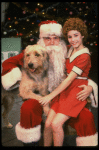 Roseanne Sorrentino as Annie w. Santa Claus and Sandy in a scene from the touring company of the musical "Annie." (Louisville)
