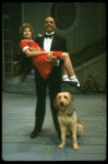 Bridget Walsh as Annie and Rhodes Reason as Daddy Warbucks w. Sandy in a scene from a touring company of the musical "Annie." (Fort Worth)