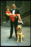 Bridget Walsh as Annie and Rhodes Reason as Daddy Warbucks w. Sandy in a scene from a touring company of the musical "Annie." (Fort Worth)