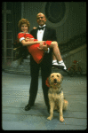 Bridget Walsh as Annie and Rhodes Reason as Daddy Warbucks w. Sandy in a scene from a touring company of the musical "Annie." (Fort Worth)