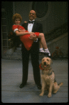 Bridget Walsh as Annie and Rhodes Reason as Daddy Warbucks w. Sandy in a scene from a touring company of the musical "Annie." (Fort Worth)