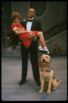 Bridget Walsh as Annie and Rhodes Reason as Daddy Warbucks w. Sandy in a scene from a touring company of the musical "Annie." (Fort Worth)