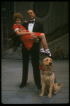 Bridget Walsh as Annie and Rhodes Reason as Daddy Warbucks w. Sandy in a scene from a touring company of the musical "Annie." (Fort Worth)