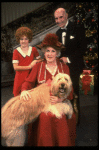 Ruth Kobart as Miss Hannigan, Louanne as Annie, and Norwood Smith as Daddy Warbucks w. Sandy in a scene from a touring company of the musical "Annie." (Boston)