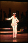 Actress Liza Minnelli wearing a white suit w. a fedora designed by Halston in a scene from the Broadway production of the musical "The Act." (New York)
