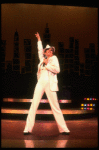 Actress Liza Minnelli wearing a white suit w. a fedora designed by Halston in a scene from the Broadway production of the musical "The Act." (New York)