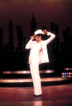Actress Liza Minnelli wearing a white suit w. a fedora designed by Halston in a scene from the Broadway production of the musical "The Act." (New York)