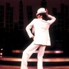 Actress Liza Minnelli wearing a white suit w. a fedora designed by Halston in a scene from the Broadway production of the musical "The Act." (New York)